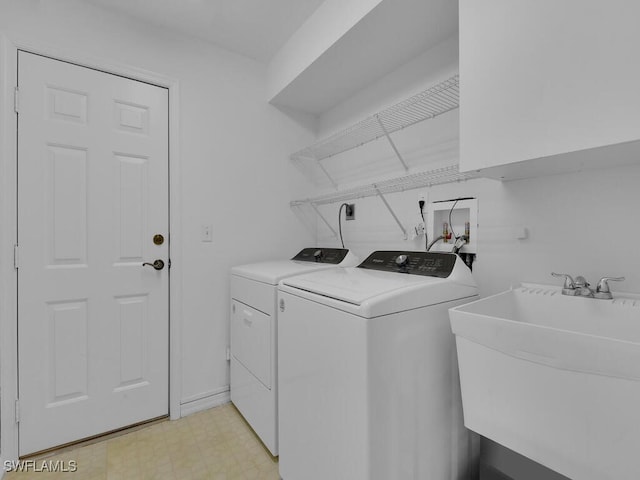 washroom featuring washing machine and dryer and sink