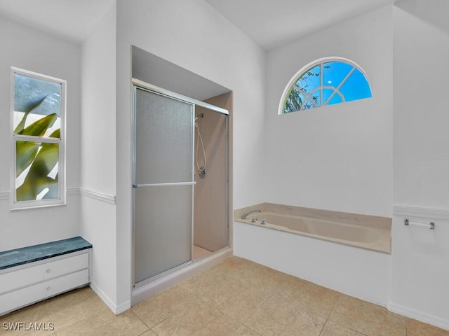 bathroom with tile patterned floors and independent shower and bath