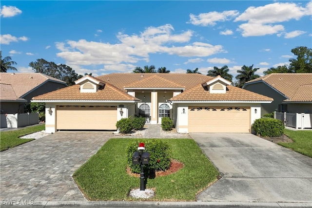 view of front of home featuring a front lawn and a garage