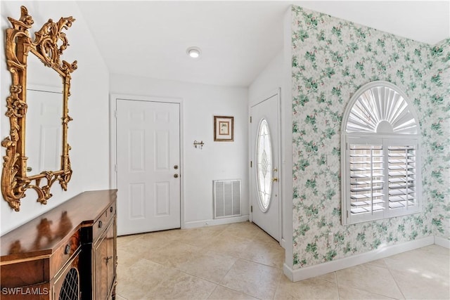 tiled entrance foyer featuring a wealth of natural light