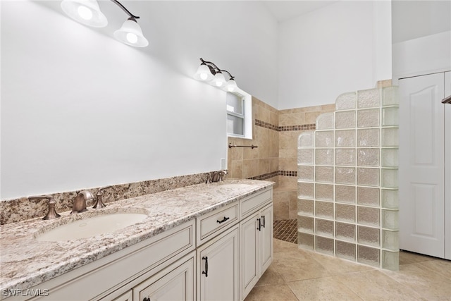 8526 Mustang Dr, Naples, FL 34113 - full bathroom with tile patterned flooring, a sink, double vanity, and a walk in shower