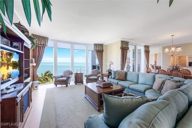 living room with expansive windows, a water view, and a chandelier