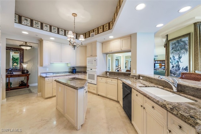 kitchen with white appliances, sink, light stone countertops, decorative light fixtures, and kitchen peninsula