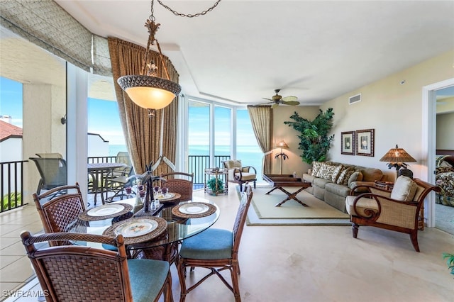 dining room with floor to ceiling windows and ceiling fan