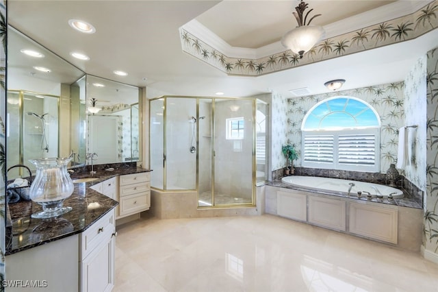 bathroom with a raised ceiling, vanity, separate shower and tub, and ornamental molding