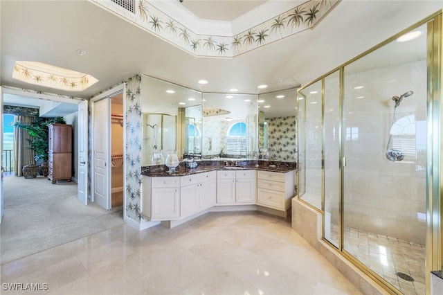 bathroom with vanity and a shower with door