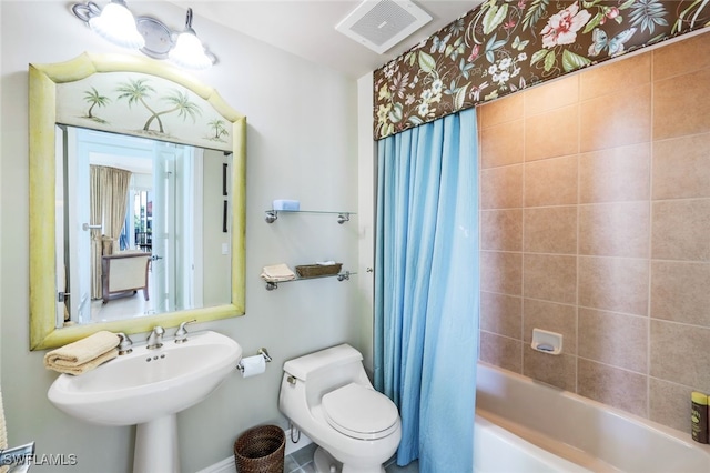 full bathroom with shower / bath combination with curtain, toilet, and sink