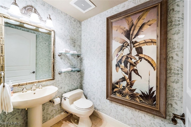 bathroom with tile patterned floors, toilet, and sink