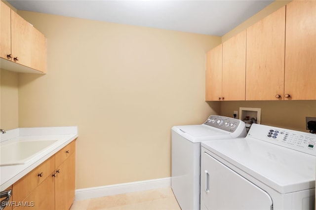 laundry area with washer and dryer, cabinets, and sink