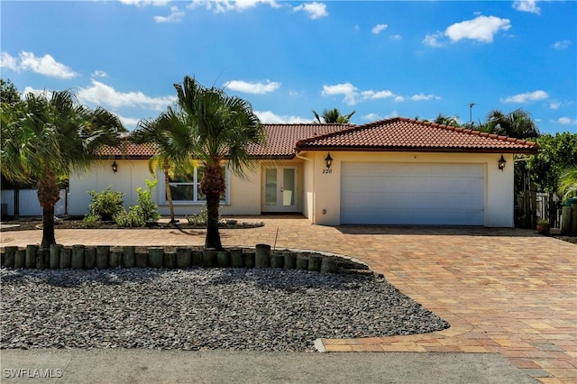 mediterranean / spanish-style home with french doors and a garage