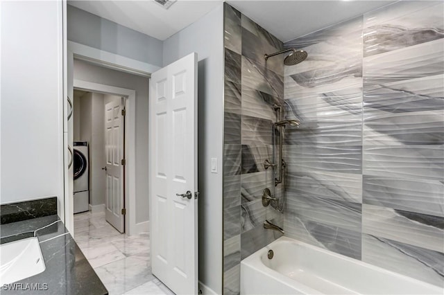 bathroom with vanity, shower / tub combination, and washer / clothes dryer