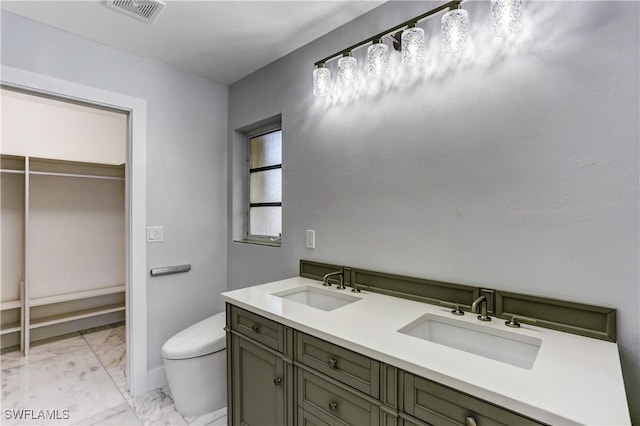 bathroom with vanity and toilet