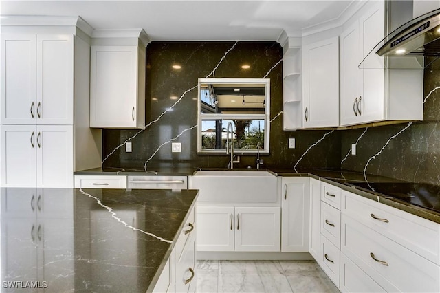 kitchen featuring tasteful backsplash, sink, and white cabinets