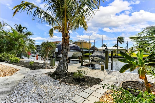 surrounding community featuring a dock and a water view