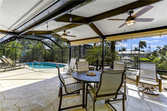 view of patio / terrace featuring a lanai and ceiling fan