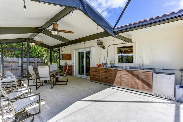 view of patio / terrace with area for grilling, ceiling fan, and sink