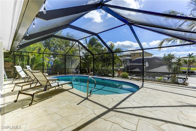 view of pool with a patio and a lanai