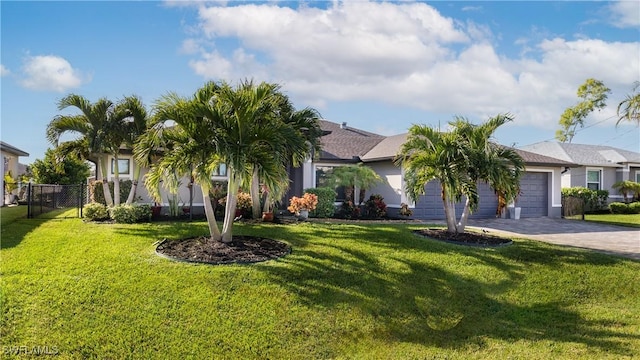 view of front of property featuring a garage and a front lawn