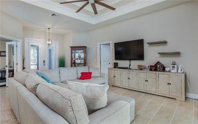 living room with a tray ceiling, crown molding, and ceiling fan with notable chandelier