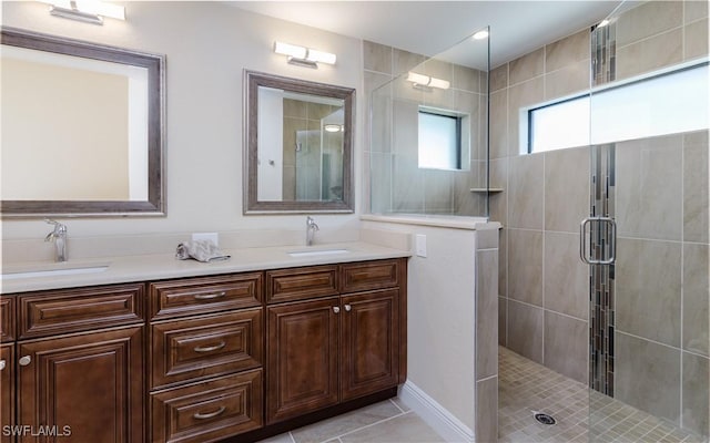 bathroom featuring tile patterned flooring, vanity, and a shower with shower door