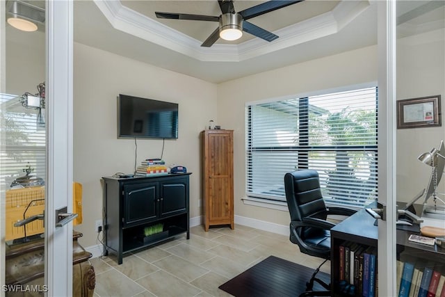 tiled office featuring a tray ceiling, ceiling fan, and ornamental molding