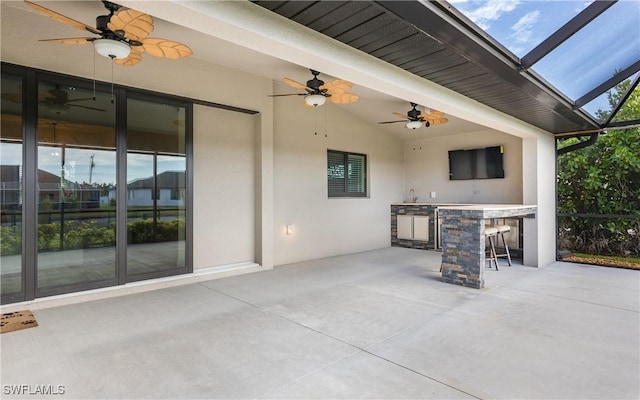 view of patio / terrace featuring a lanai and an outdoor bar