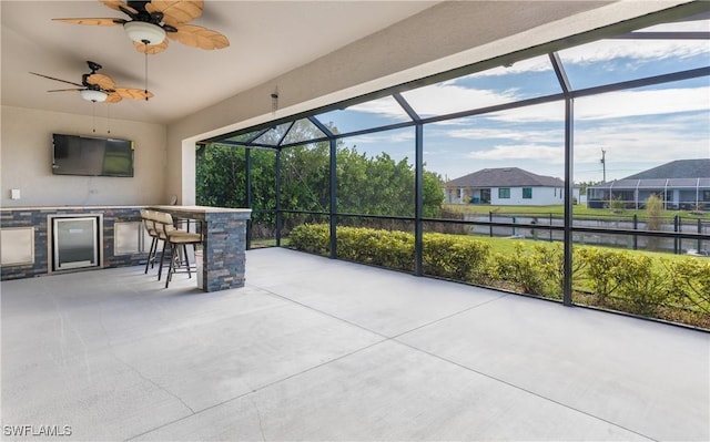 sunroom featuring a wealth of natural light, wine cooler, and ceiling fan