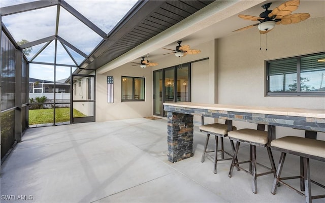 sunroom / solarium featuring ceiling fan