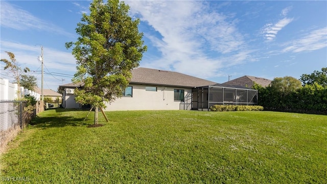 rear view of house with a lawn