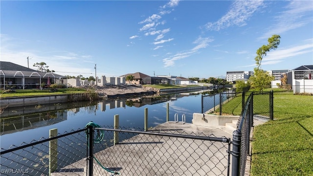 dock area with a yard and a water view