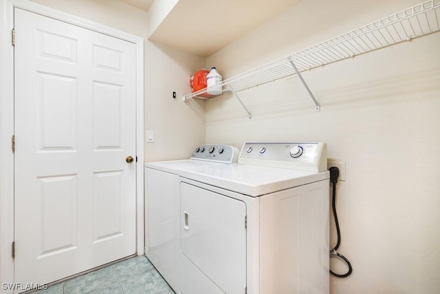 laundry room with light tile patterned floors and independent washer and dryer