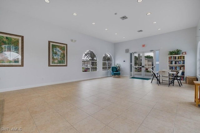 interior space with plenty of natural light, light tile patterned floors, and french doors