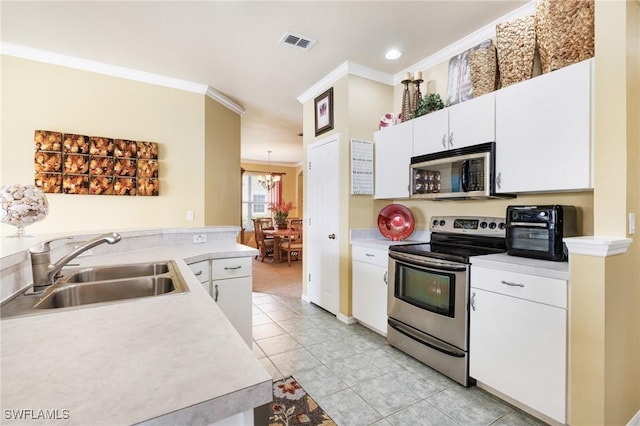 kitchen with white cabinets, crown molding, sink, light tile patterned flooring, and stainless steel appliances