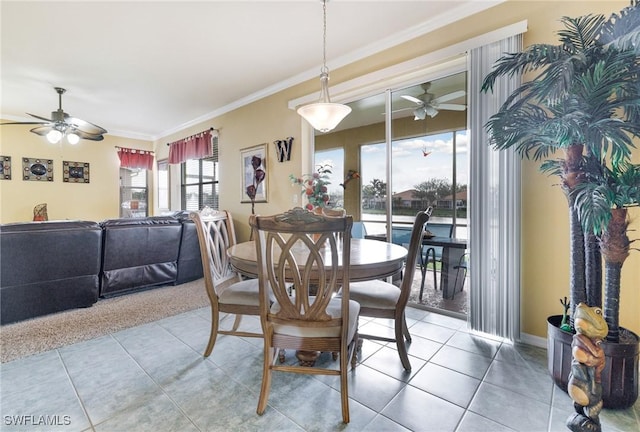 dining space with crown molding, tile patterned flooring, and ceiling fan