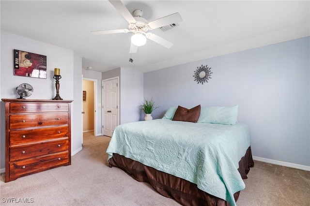 bedroom featuring light carpet, a closet, and ceiling fan