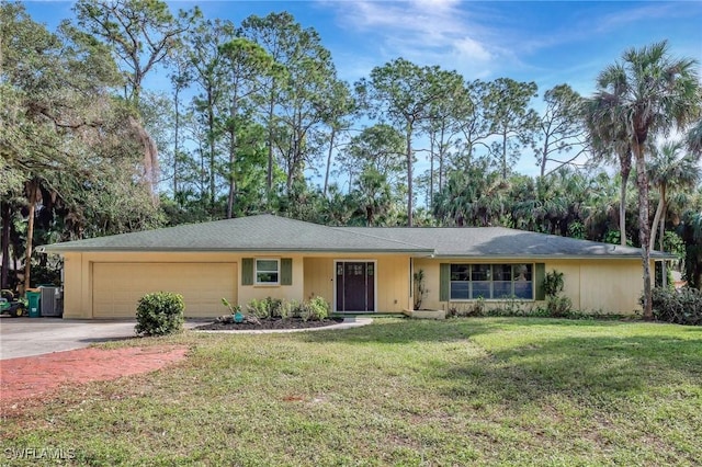 ranch-style home with a front lawn and a garage