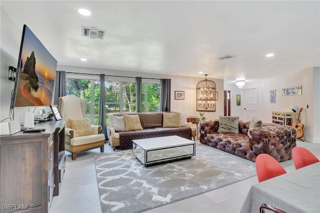 living room with a chandelier and light tile patterned floors