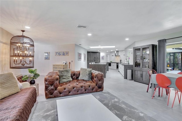 living room with sink and a chandelier