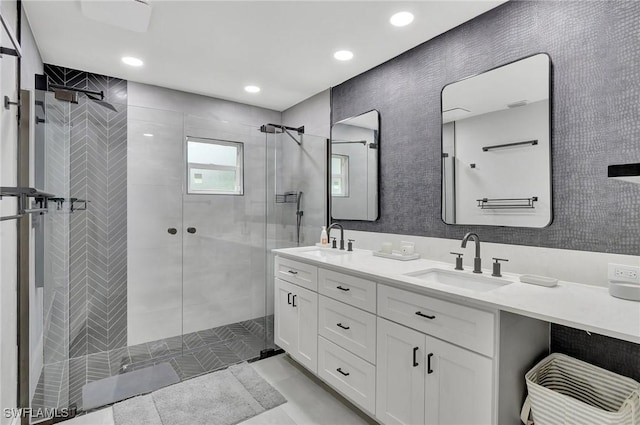 bathroom with vanity and tiled shower