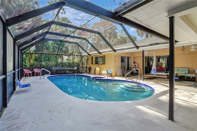 view of swimming pool featuring a lanai, a patio area, ceiling fan, and an outdoor living space