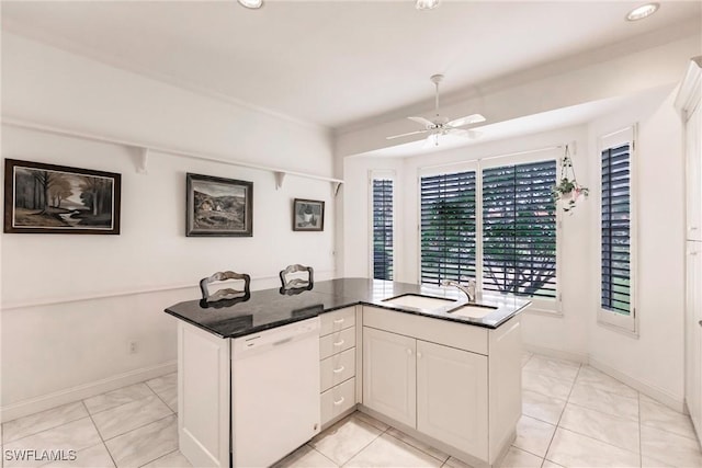 kitchen featuring white cabinetry, dishwasher, ceiling fan, sink, and a kitchen island