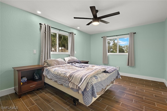 bedroom with ceiling fan and multiple windows