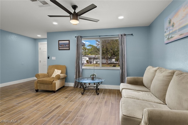 living area featuring ceiling fan and hardwood / wood-style flooring