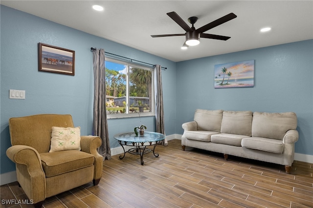 living area featuring hardwood / wood-style floors and ceiling fan