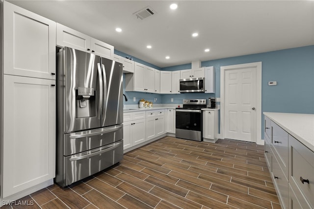 kitchen with sink, white cabinetry, and stainless steel appliances