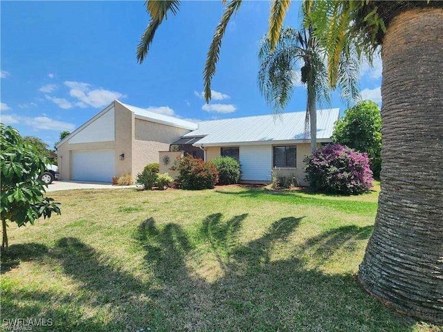 ranch-style house featuring a garage and a front yard