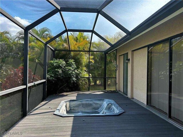 15188 Sam Snead Ln, North Fort Myers, FL 33917 - exterior space featuring hot tub deck surround and a lanai