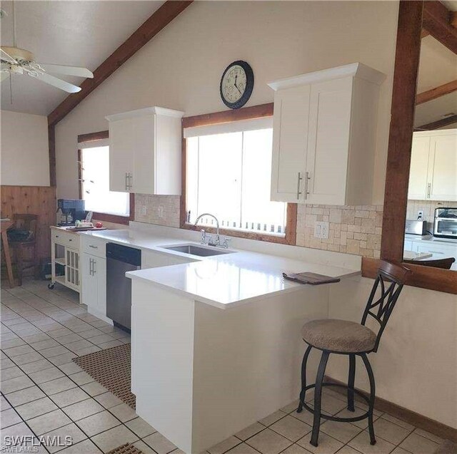 15188 Sam Snead Ln, North Fort Myers, FL 33917 - kitchen with a peninsula, light countertops, white cabinets, a sink, and dishwasher