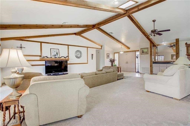 living room featuring ceiling fan, carpet, and lofted ceiling with beams