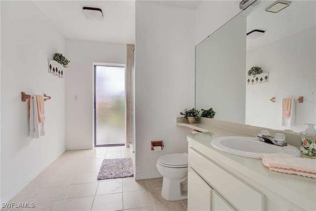 bathroom featuring tile patterned floors, vanity, and toilet